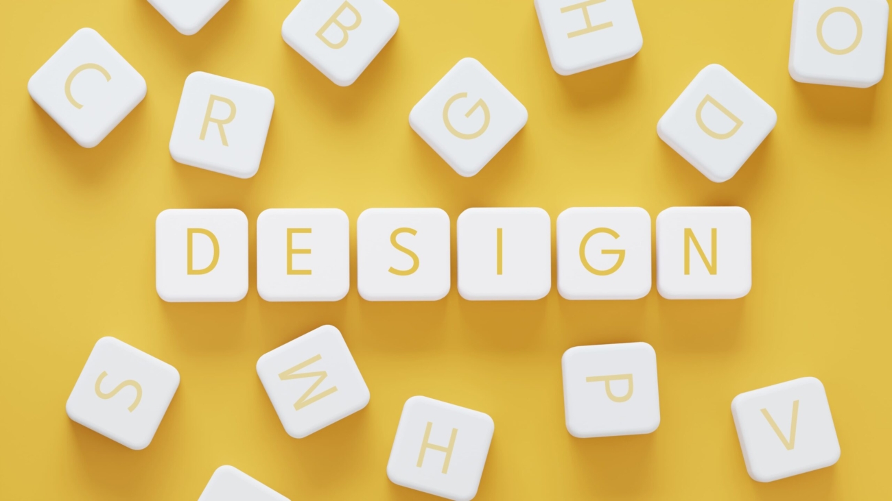 White blocks spelling 'Design' on a vibrant yellow background representing creative design solutions for startups
