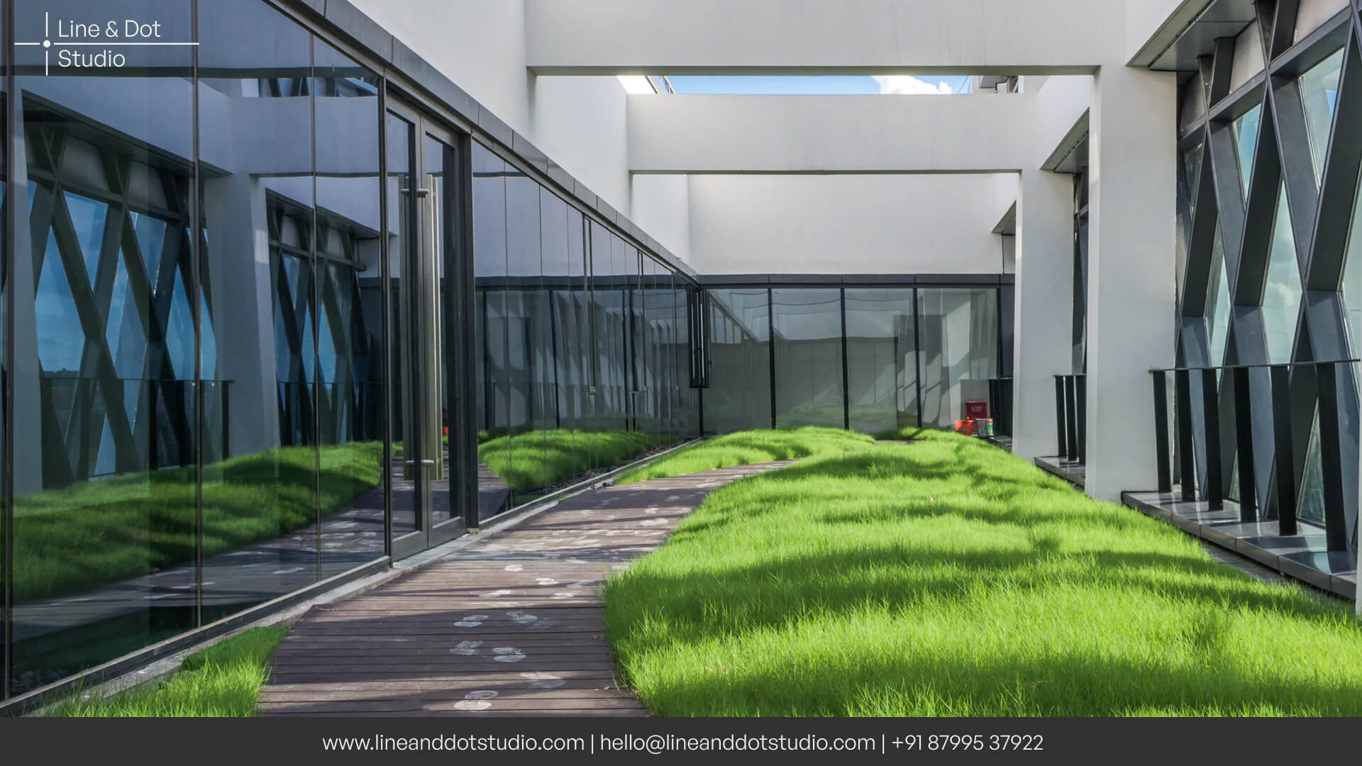 Biophilic office architecture design with a grass lawn between connecting the office spaces
