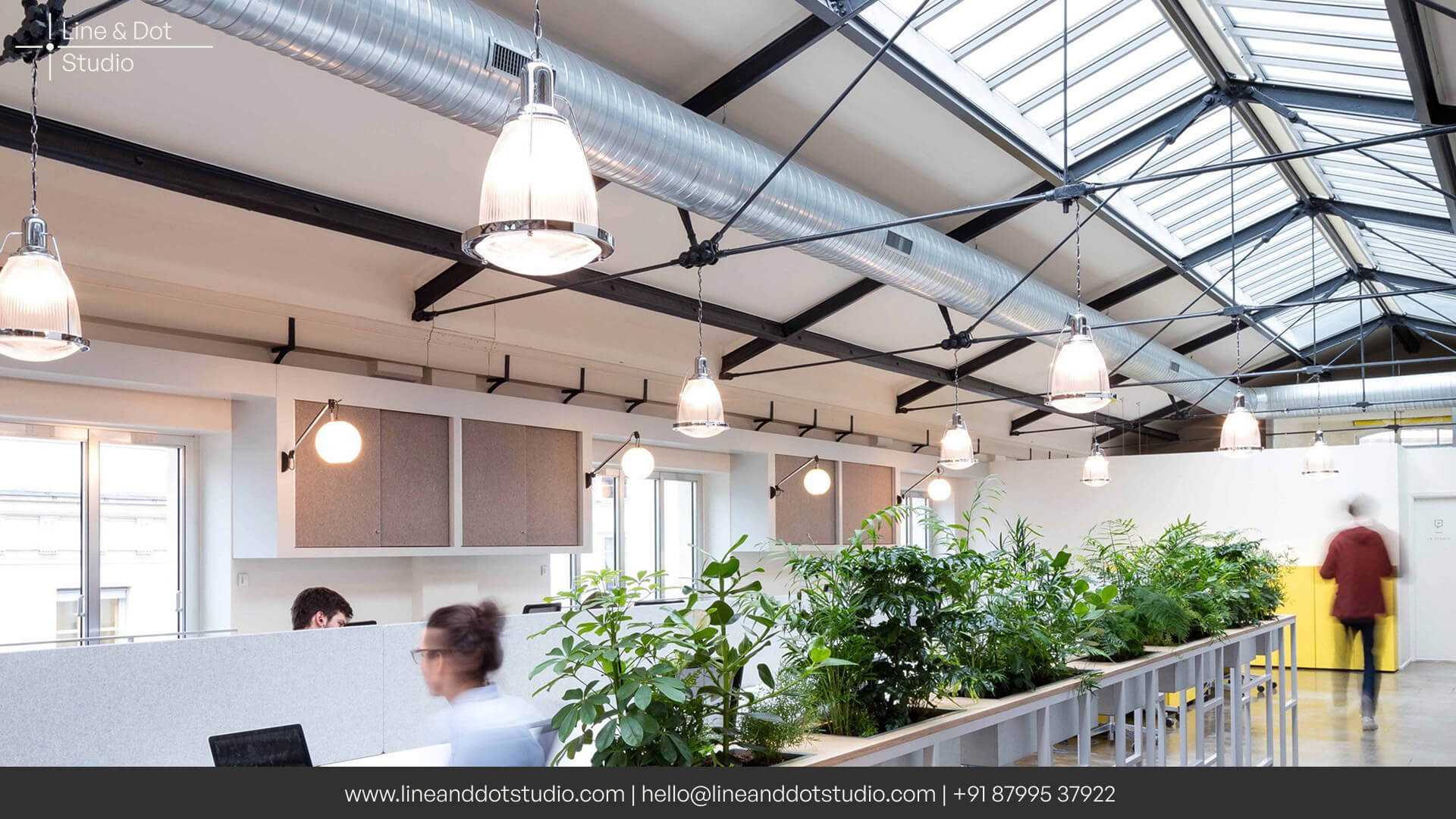 Biophilic principles inspired office space with large skylights and indoor plantation for a healthy workspace