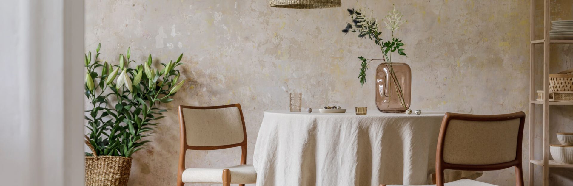 Eco friendly sustainable interior design products including bamboo dining set, jute table cloth, recycled-glass vase.